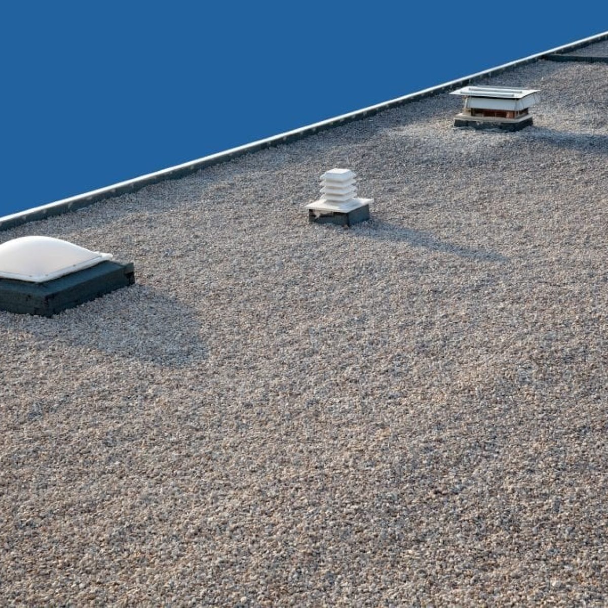 Aggregate-surfaced built-up roofing system on a commercial building